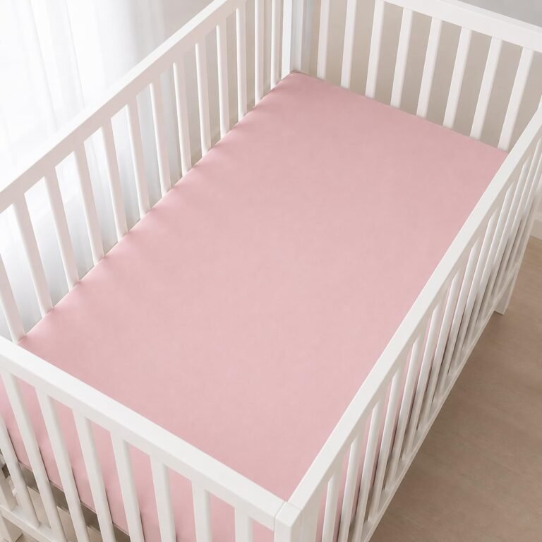 Pink Sleep Tight zipper crib sheet fitted snugly to a white crib mattress